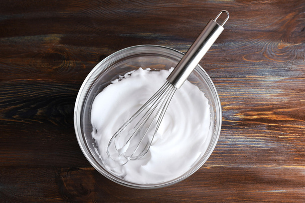 Whipped egg whites for cream on wooden table, top view - Zdjęcie, obraz