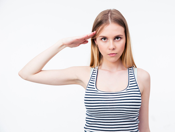 Portrait of a young cute woman saluting - Фото, изображение