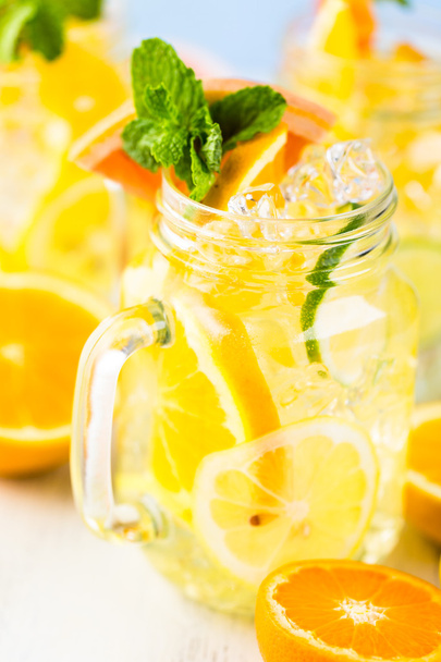 Water with fresh citrus fruits and ice - Photo, Image