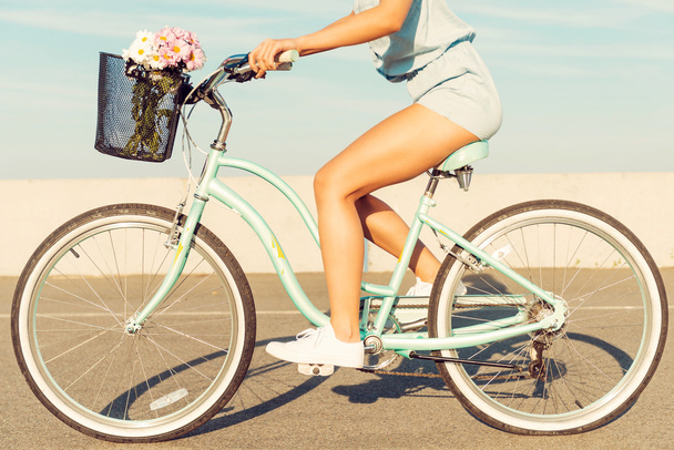 young woman riding on her bicycle - Φωτογραφία, εικόνα