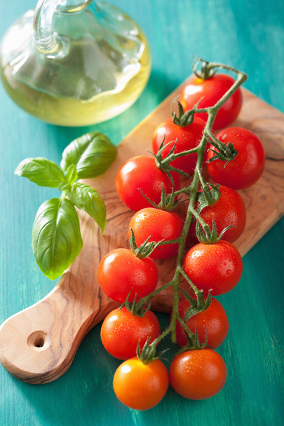 cherry tomatoes and olive oil over turquoise background - Fotoğraf, Görsel