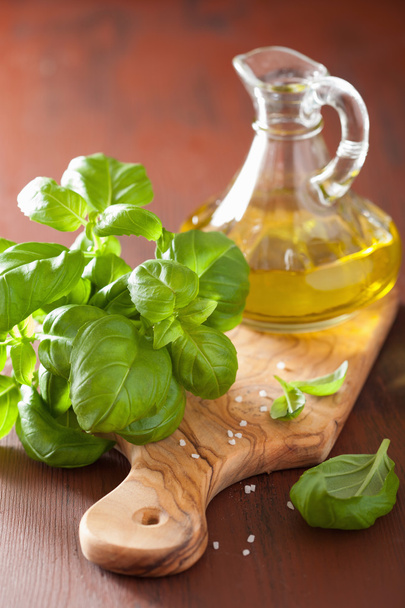 fresh basil leaves herb and olive oil on wooden background - Foto, Imagem