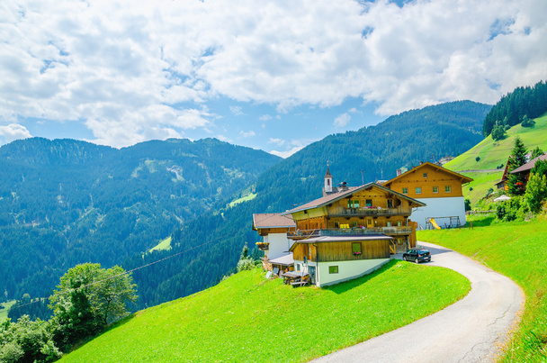 Edificio alpino con prati verdi e alte cime
 - Foto, immagini