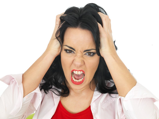 Portrait of a Young Attractive Hispanic Woman Holding Her Hair Screaming - Photo, Image