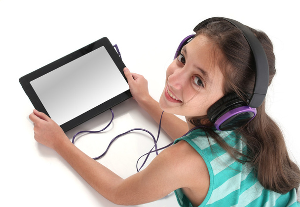 Beautiful pre-teen girl on the floor, using a tablet computer - Zdjęcie, obraz