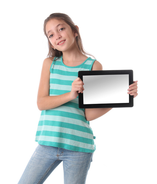 Beautiful pre-teen girl with a tablet computer. Isolated - 写真・画像