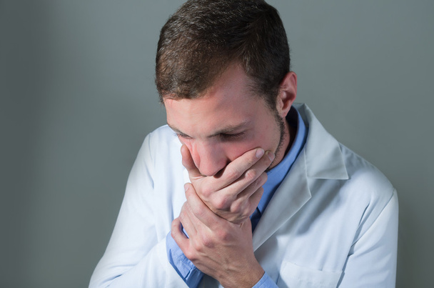 Closeup portrait of shocked young doctor covering mouth - Foto, Bild