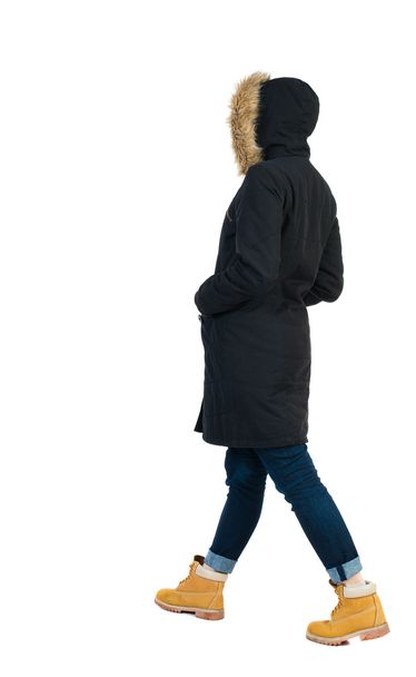 Back view of woman in parka. - Фото, изображение