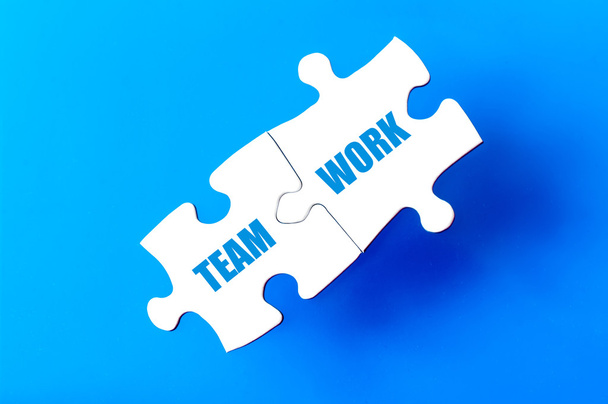 Connected puzzle pieces with words TEAM and WORK - Φωτογραφία, εικόνα
