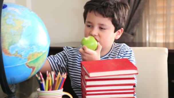 Elementary age boy posing on a stack of books. - Záběry, video