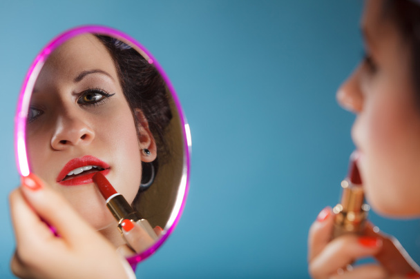 Woman applying red lipstick - Фото, зображення
