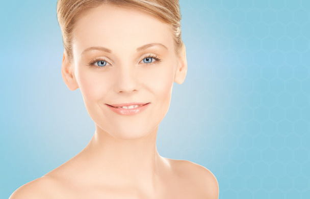 beautiful young woman face over blue background - Photo, Image