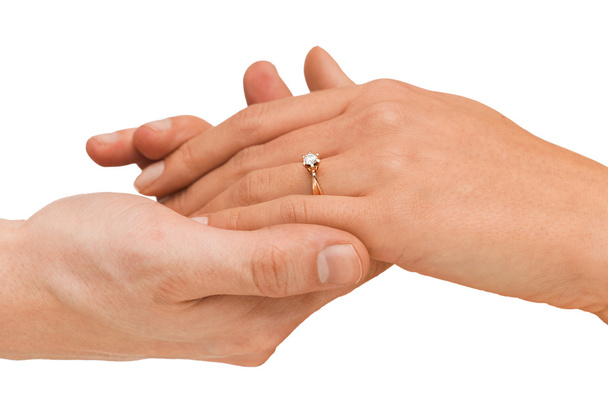 man puts wedding ring on woman hand - Fotó, kép