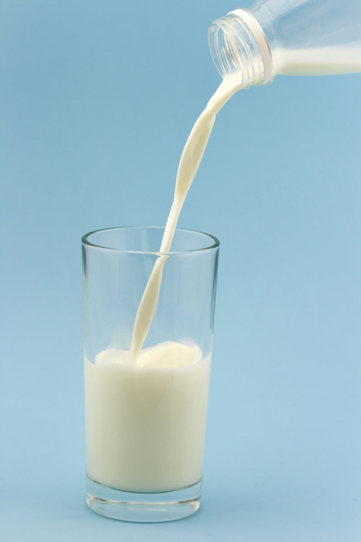 Milk is poured into a glass cup - Fotoğraf, Görsel