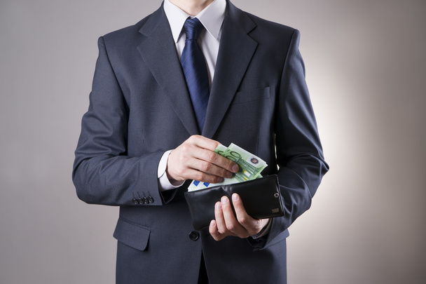 Businessman with money in purse in hands - Foto, afbeelding