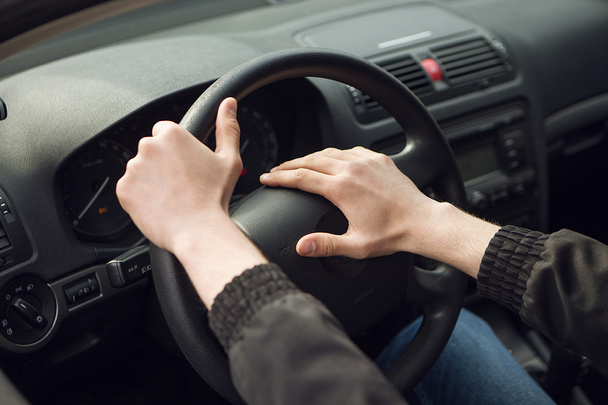 Close-up of  male hand on steering wheel in car - Fotoğraf, Görsel