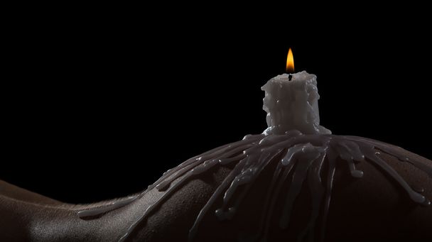 Body scape of a well-shaped woman with burning candle and wax on - Фото, изображение