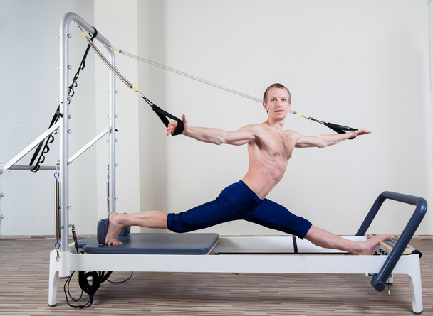Pilates reformer workout exercises man at gym indoor - Foto, afbeelding
