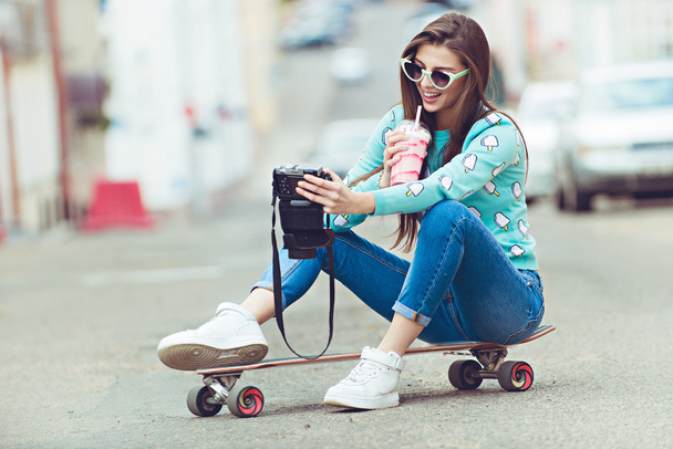 Красивая молодая женщина позирует со скейтбордом, стиль жизни на закате
 - Фото, изображение