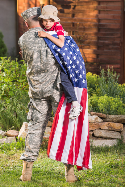 Military man father hugs son - Фото, зображення