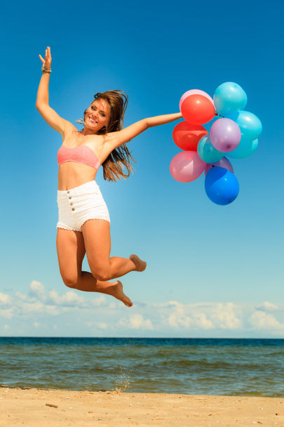 Girl jumping with colorful balloons - Photo, Image