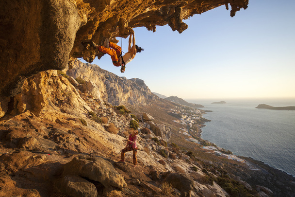 Young woman lead climbing on overhanging cliff - Photo, Image