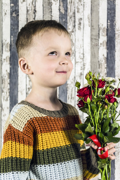 boy holding a bouquet of flowers, holiday - Foto, Imagen