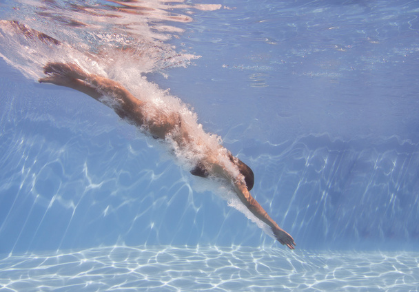female swimmer after jumping with air bubbles trail - Photo, Image