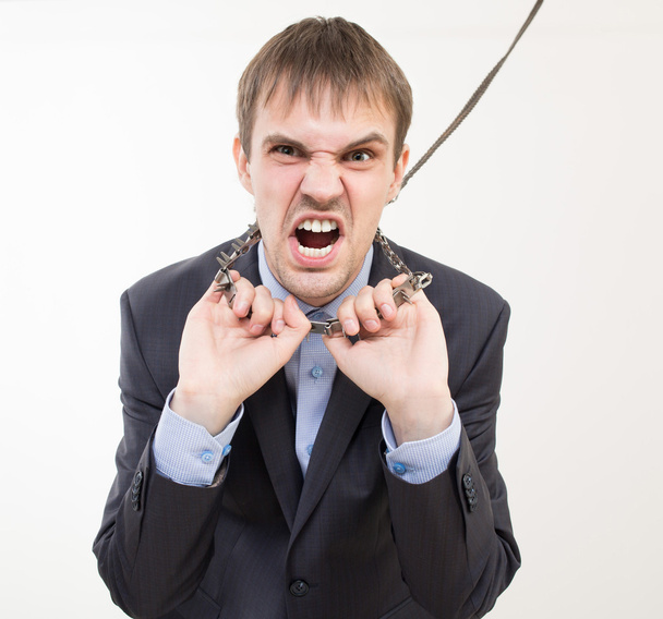 Angry businessman on the chain with a collar. - Photo, Image