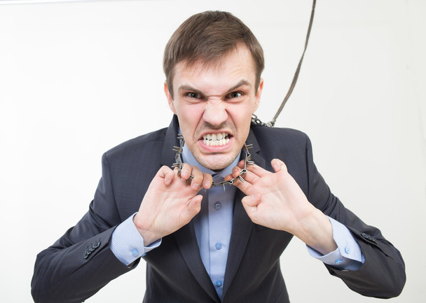 Angry businessman on the chain with a collar. - Photo, Image