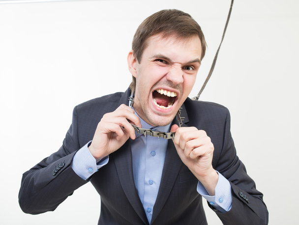Angry businessman on the chain with a collar. - Foto, Imagen
