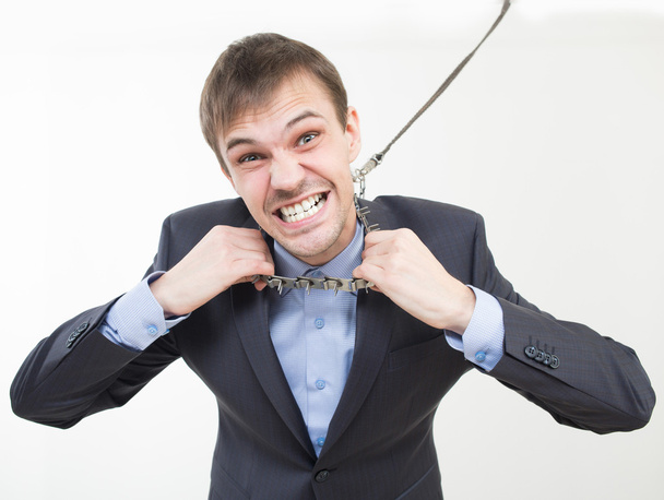 Angry businessman on the chain with a collar. - Φωτογραφία, εικόνα