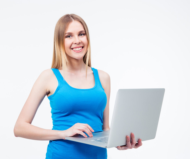 Smiling young woman standing with laptop - Fotó, kép