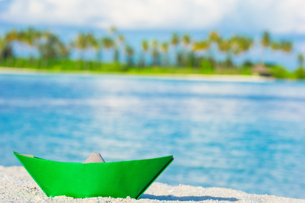 Colorful paper boat on tropical white beach outdoors - Photo, Image