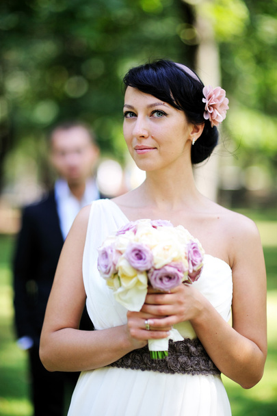 Beautiful bride posing outdoors on wedding day - Photo, Image