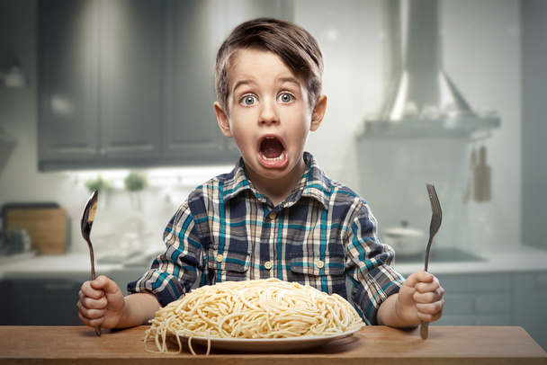Startled yound boy with noodles - Photo, Image