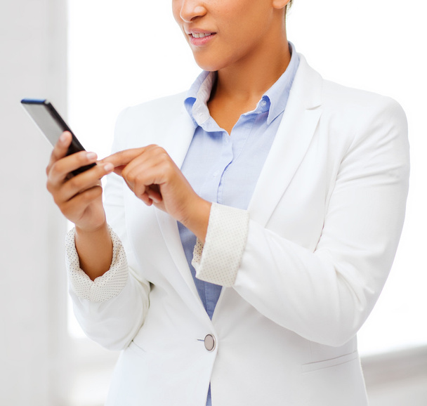 african businesswoman with smartphone in office - Photo, Image
