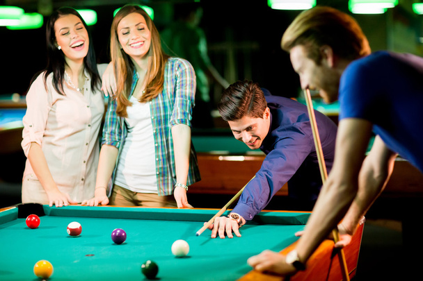 Young people playing pool - Фото, зображення