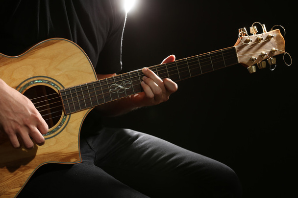 Young man playing on acoustic guitar o - Zdjęcie, obraz
