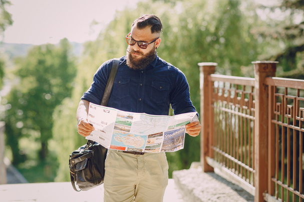 bearded man travels with map - Фото, изображение
