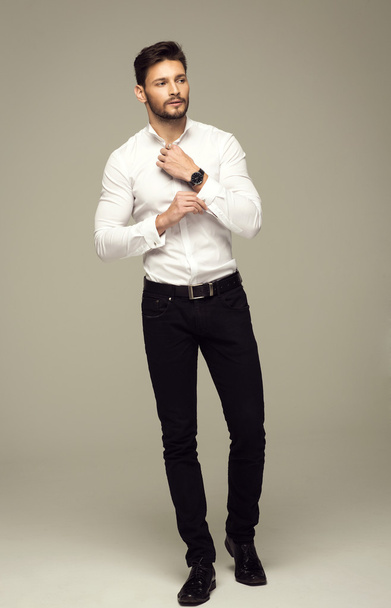 Handsome elegant man buttoning shirt - Фото, зображення