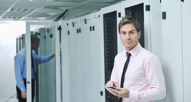 It engineers in network server room - Photo, image