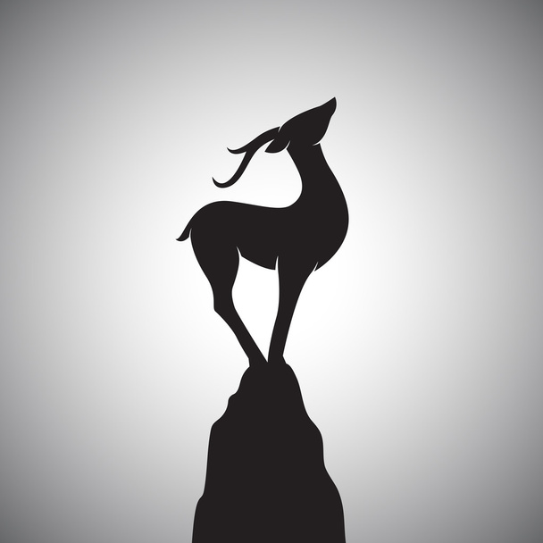 Imagen vectorial de un ciervo parado sobre las rocas. - Vector, Imagen