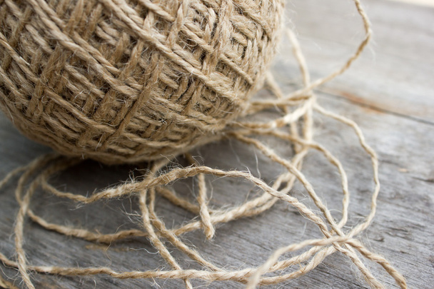 Wool ball of threads on wooden table - Фото, зображення