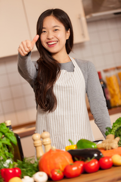 Asian woman is making positive thumb gesture - Photo, Image