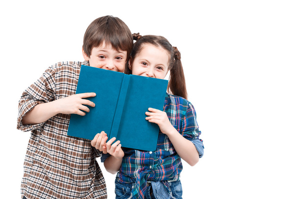 Brother and sister posing with a book - Foto, Imagen
