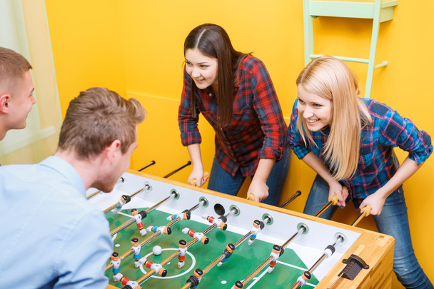 Happy friends playing table hockey - Photo, Image