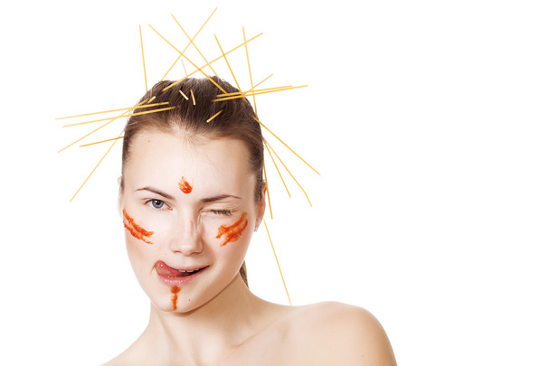 Girl with spaghetti and tomato sauce on cheeks winking - Φωτογραφία, εικόνα