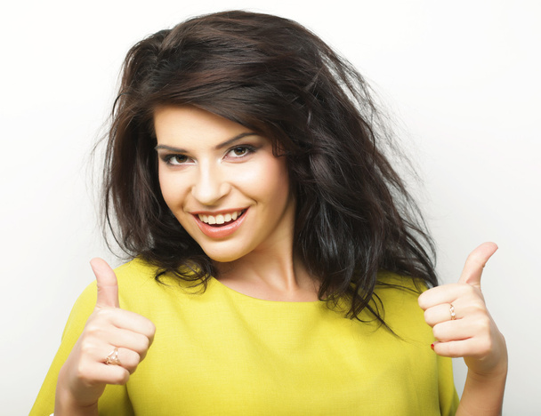 young woman showing thumbs up gesture  - Photo, Image