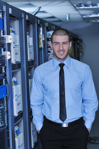 Young it engineer in datacenter server room - Photo, image